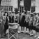 British filmmaker Frank Launder (1906- 1997, seated, centre) with actor Guy Middleton and a group of schoolgirl extras at Langley Court, Liss, Hampshire during filming of the comedy ‘The Happiest Days of Your Life’, 19th September 1949.